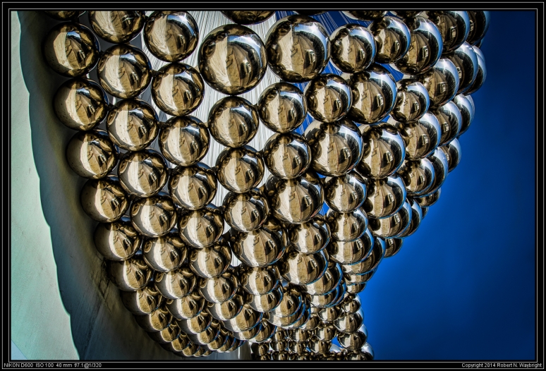 Giant shiny metal balls on a building